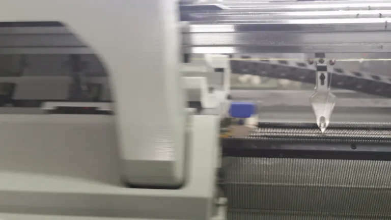 Needle bed and yarn-feeding area of a computerized flat knitting machine
