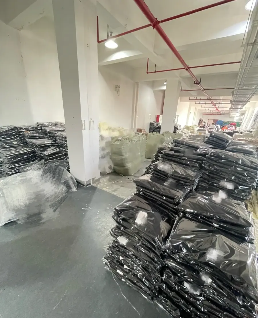 Packed bulk sweater orders prepared after production checks at TYKNIT