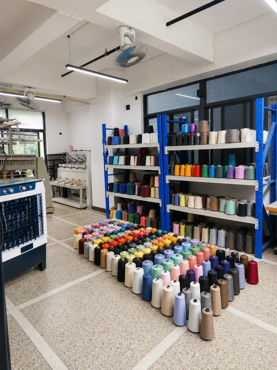 TYKNIT yarn color selection room with organized yarn cones for custom knitwear sampling